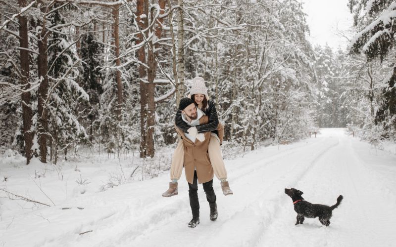 couple and dog in snow